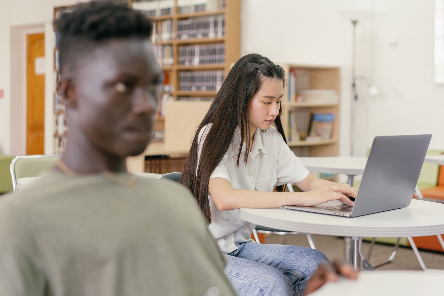 Estudantes aprendendo online com laptop em ambiente iluminado